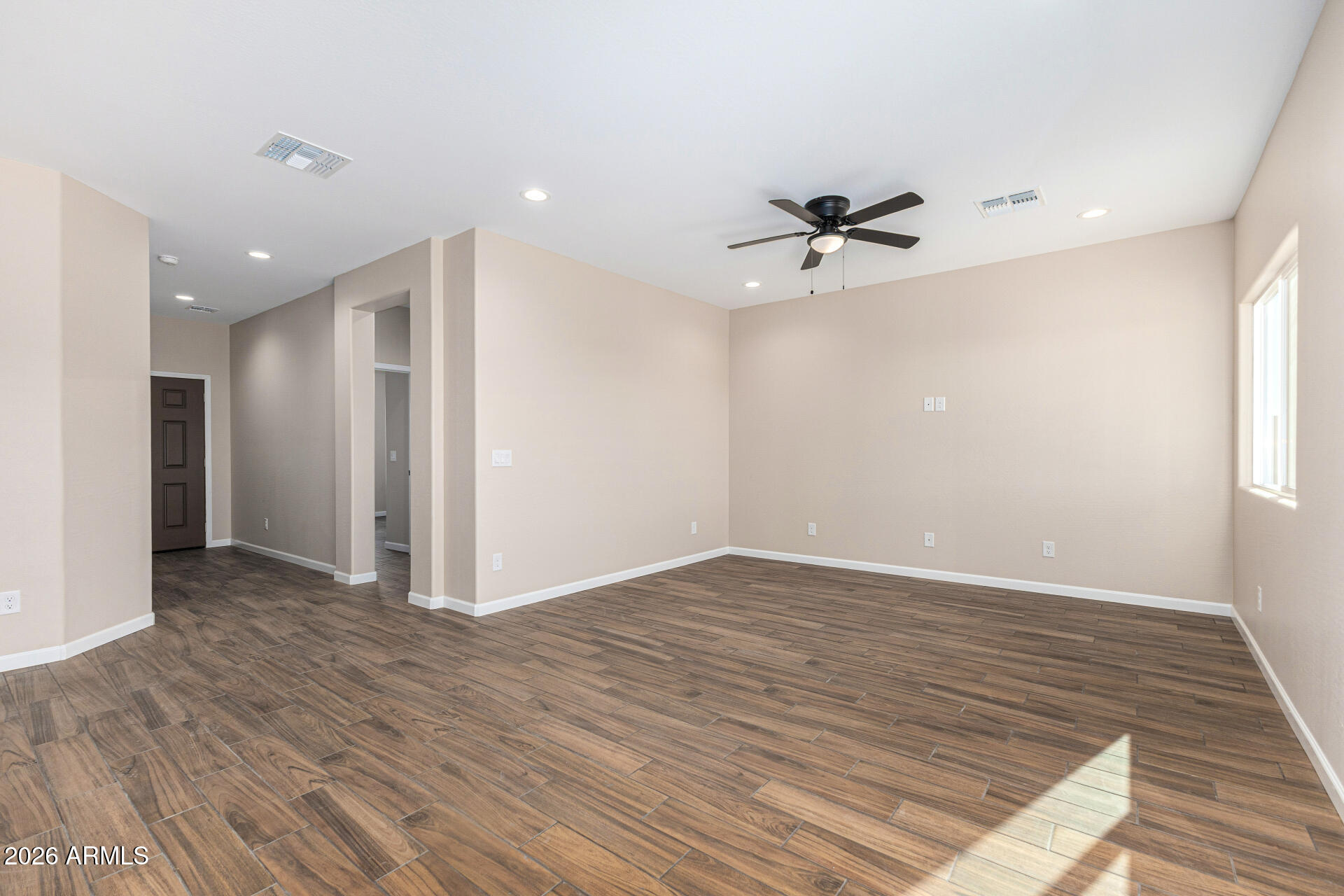14058 South Tampico Road Arizona City, AZ 85123 - Photo 14 of 37 wooden floor in an empty room with a window