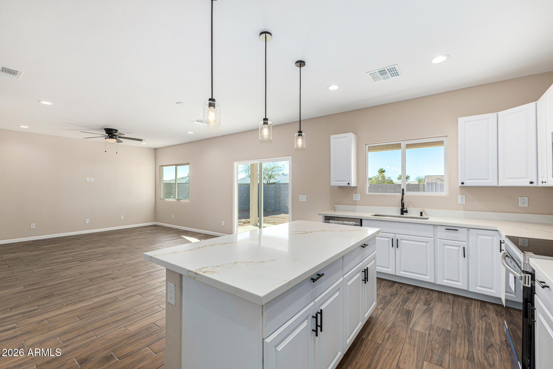 14058 South Tampico Road Arizona City, AZ 85123 - Photo 18 of 37 a view of a kitchen counter space a sink wooden floor and a window