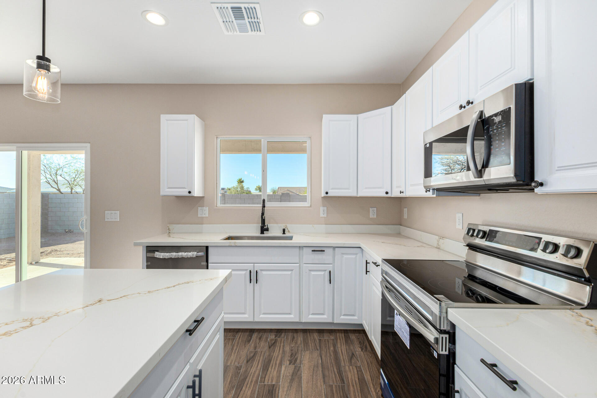 14058 South Tampico Road Arizona City, AZ 85123 - Photo 19 of 37 a kitchen with a sink a stove and cabinets
