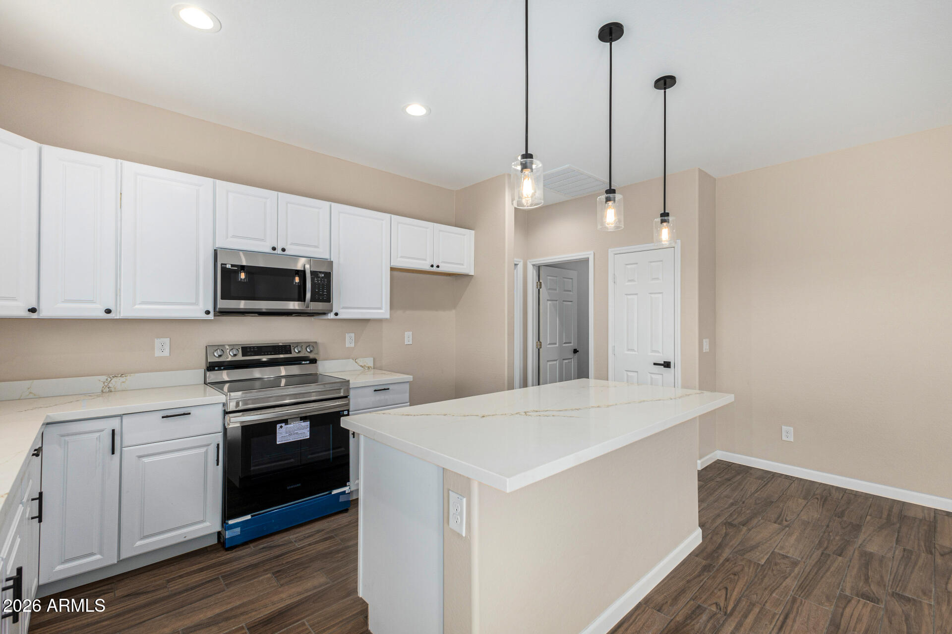 14058 South Tampico Road Arizona City, AZ 85123 - Photo 21 of 37 a kitchen with stainless steel appliances granite countertop a sink a stove a refrigerator and white cabinets