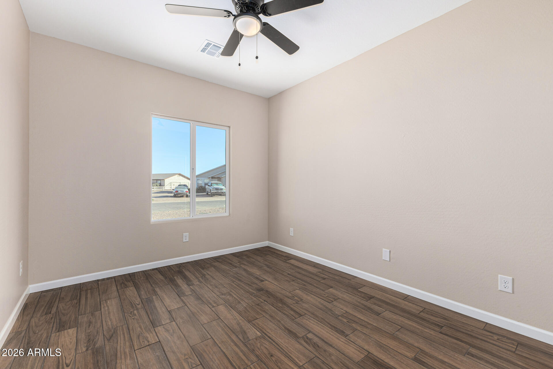 14058 South Tampico Road Arizona City, AZ 85123 - Photo 29 of 37 wooden floor in an empty room with a window