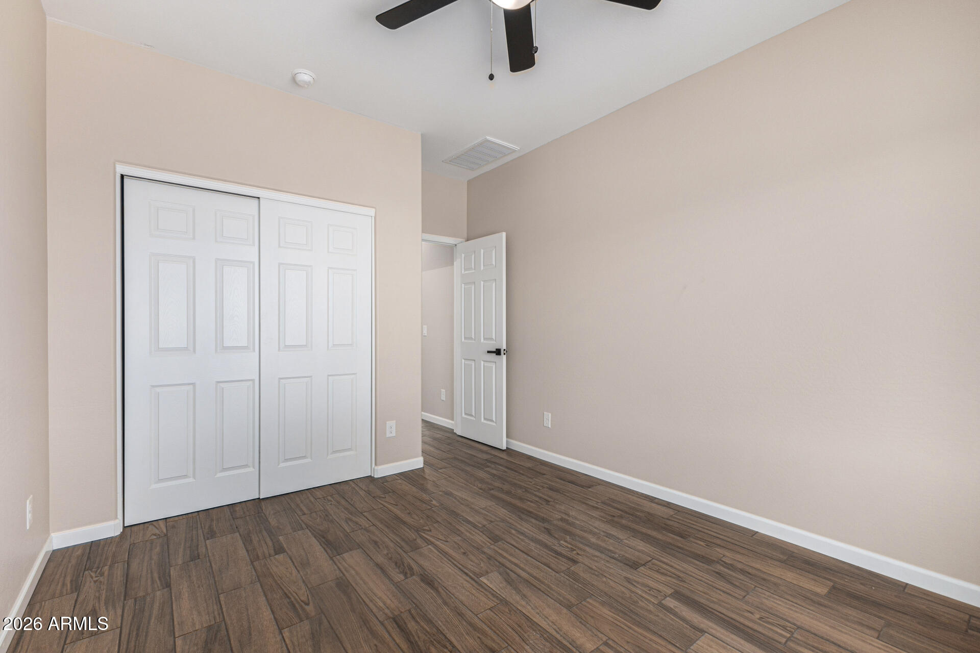 14058 South Tampico Road Arizona City, AZ 85123 - Photo 30 of 37 an empty room with a hardwood and ceiling fan