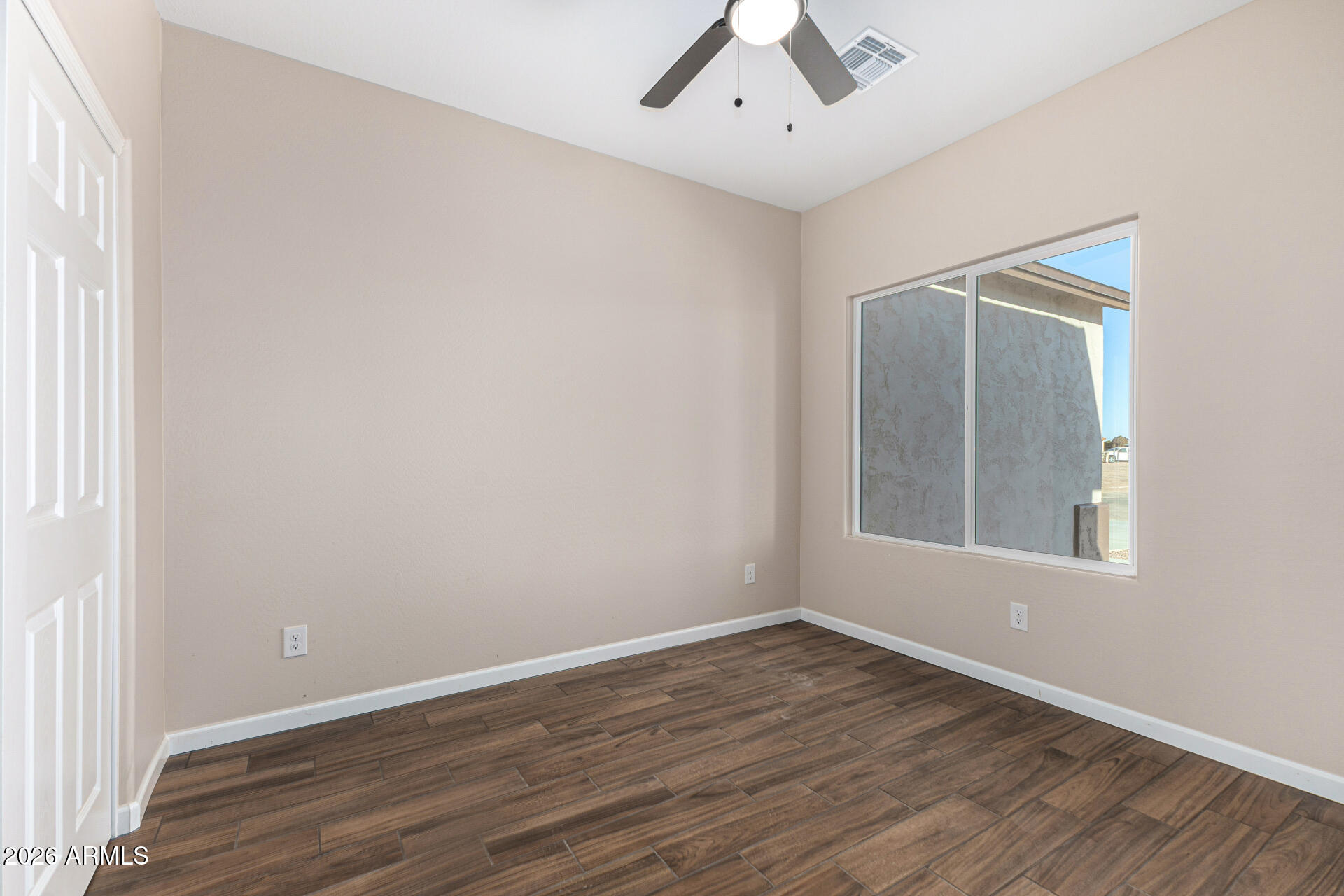 14058 South Tampico Road Arizona City, AZ 85123 - Photo 31 of 37 an empty room with wooden floor and windows