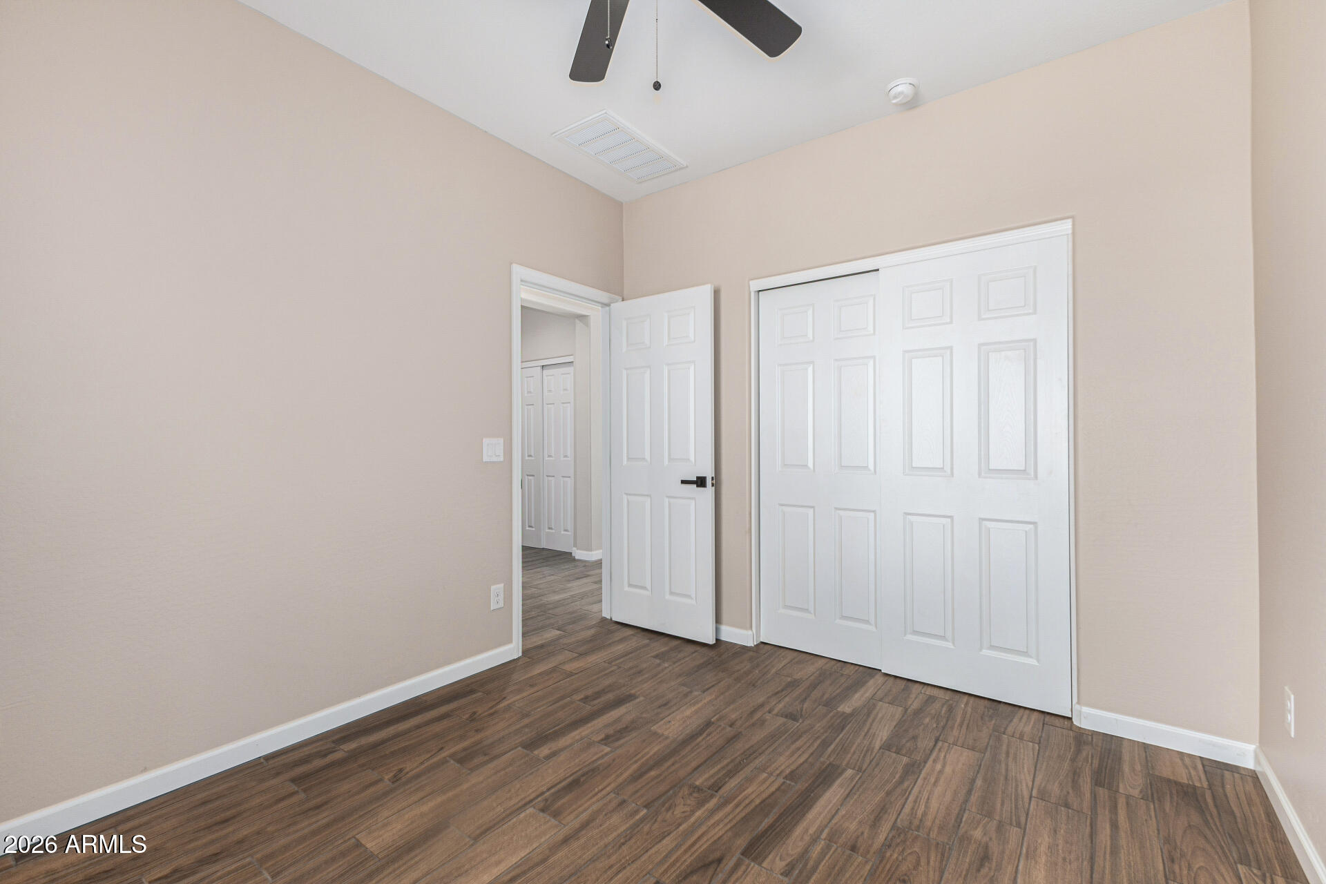 14058 South Tampico Road Arizona City, AZ 85123 - Photo 32 of 37 an empty room with a hardwood and ceiling fan