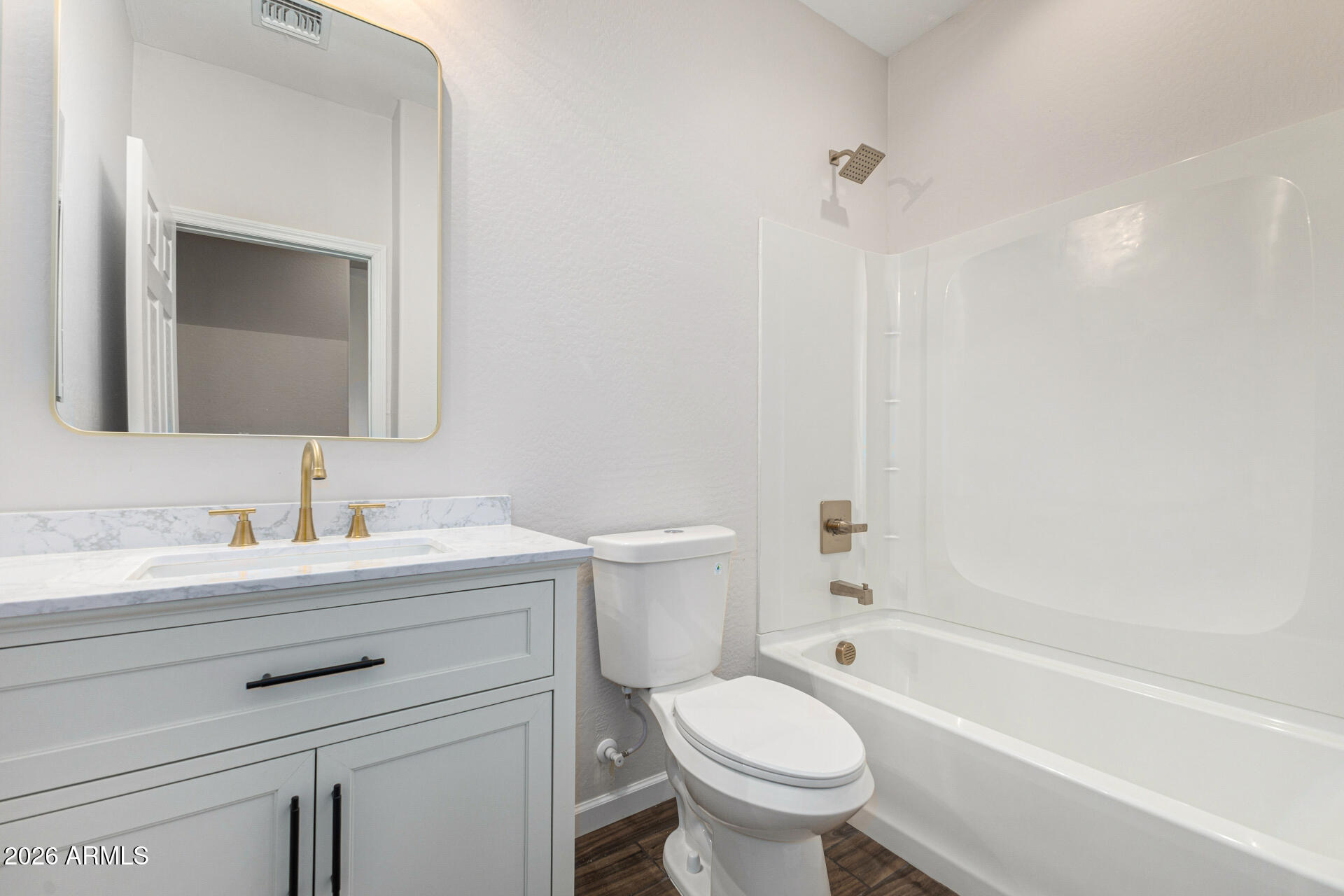 14058 South Tampico Road Arizona City, AZ 85123 - Photo 33 of 37 a bathroom with a granite countertop toilet a sink and a bathtub