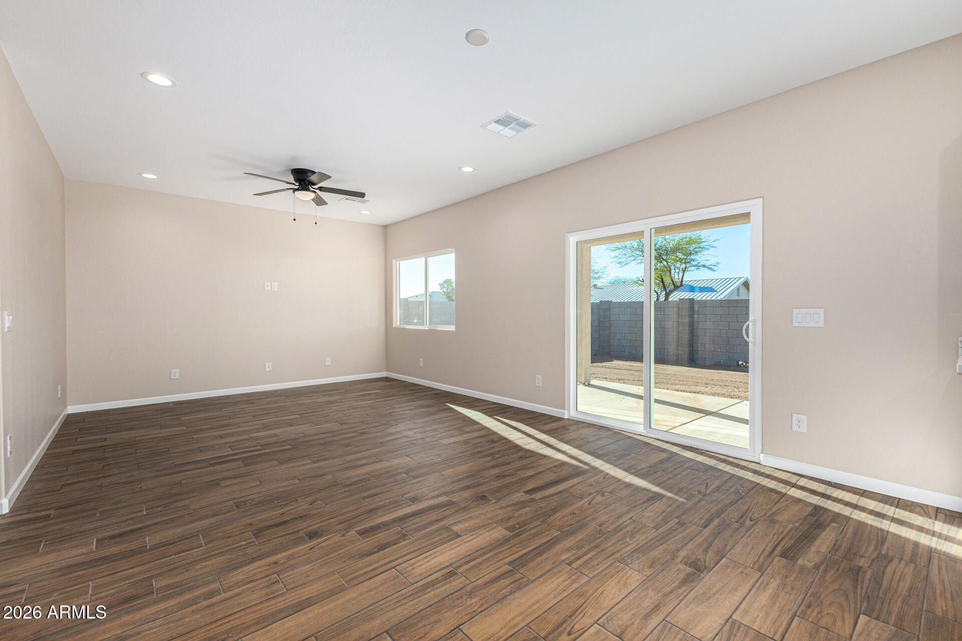 14058 South Tampico Road Arizona City, AZ 85123 - Photo 10 of 37 a view of an empty room with glass door and wooden floor