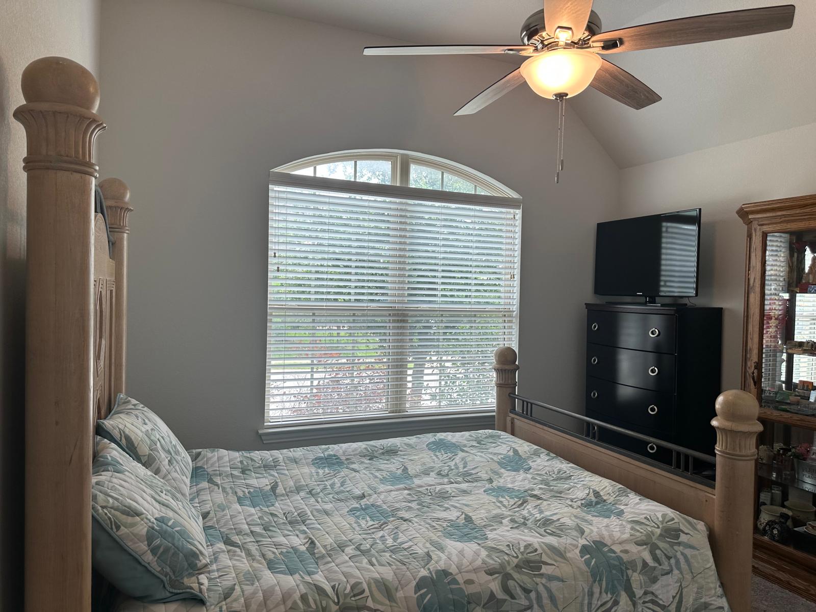 862 Leadtree Loop Buda, TX 78610 - Photo 29 of 40 a bedroom with a bed and a flat tv screen on dresser