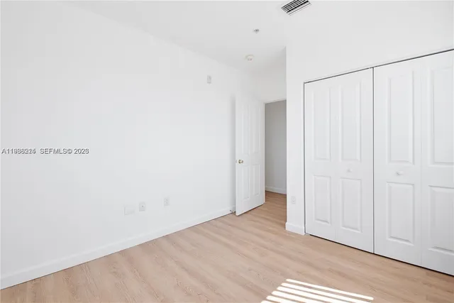 a view of a room with wooden floor