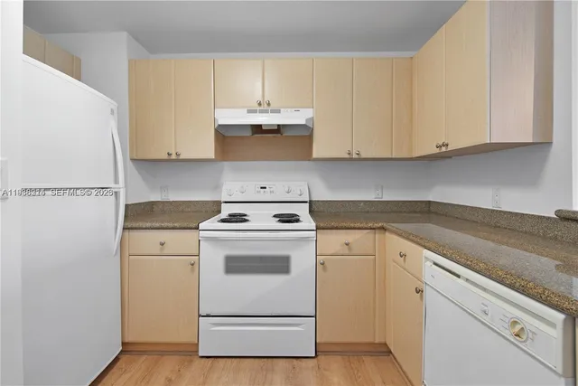 a view of a kitchen with sink and cabinets