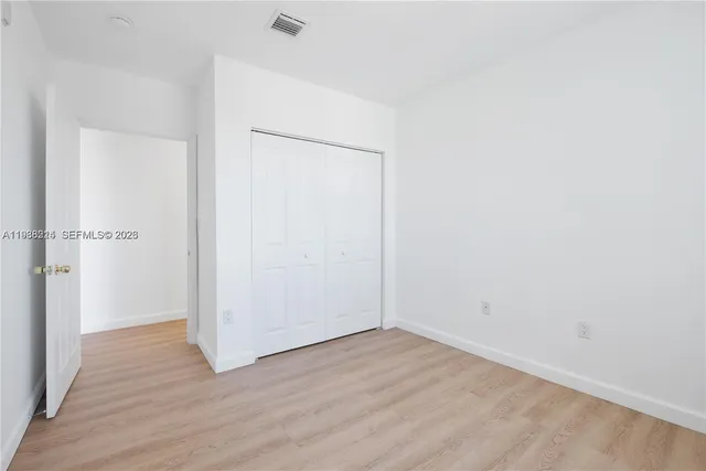 an empty room with wooden floor
