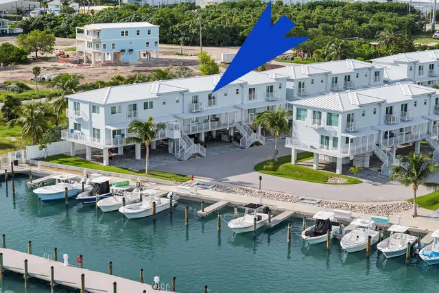 a view of a house with a patio and a yard