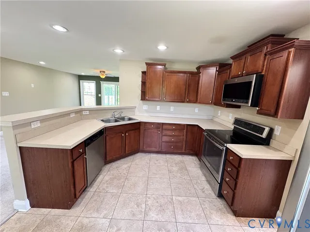 a large kitchen with stainless steel appliances granite countertop a sink and a stove