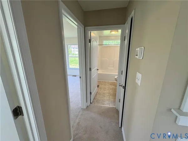 a view of a bathroom from a corridor