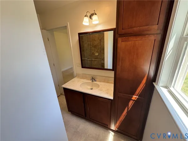 a bathroom with a sink a mirror and vanity