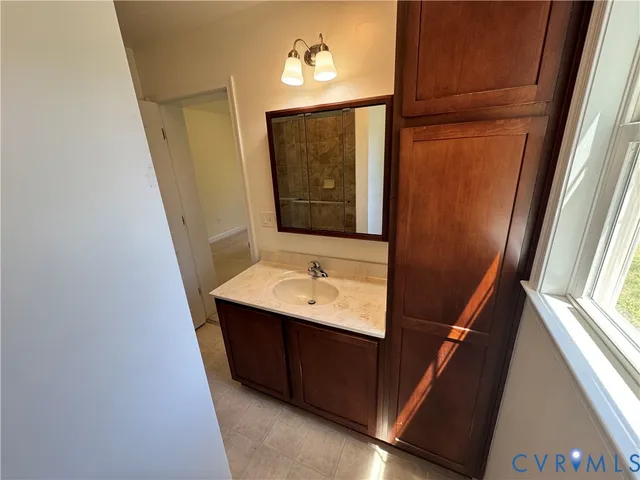 a bathroom with a sink a mirror and vanity