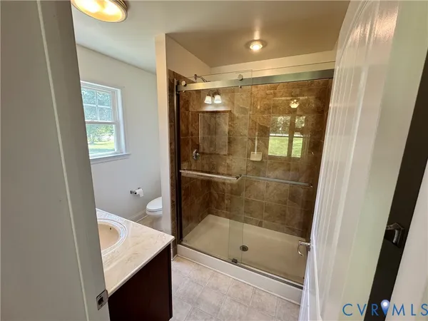 a bathroom with a shower and a sink