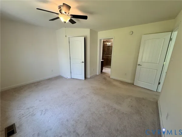 a view of empty room with ceiling fan