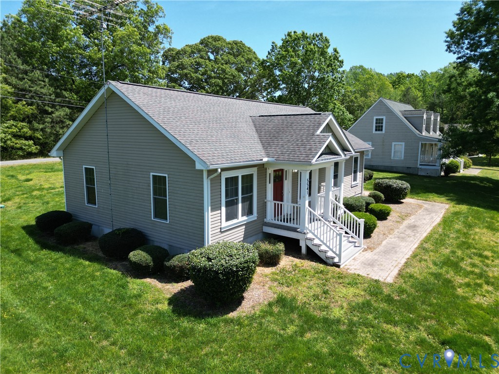 5541 Mary Ball Road Lancaster, VA 22503 - Photo 50 of 50 a front view of a house with a garden and trees