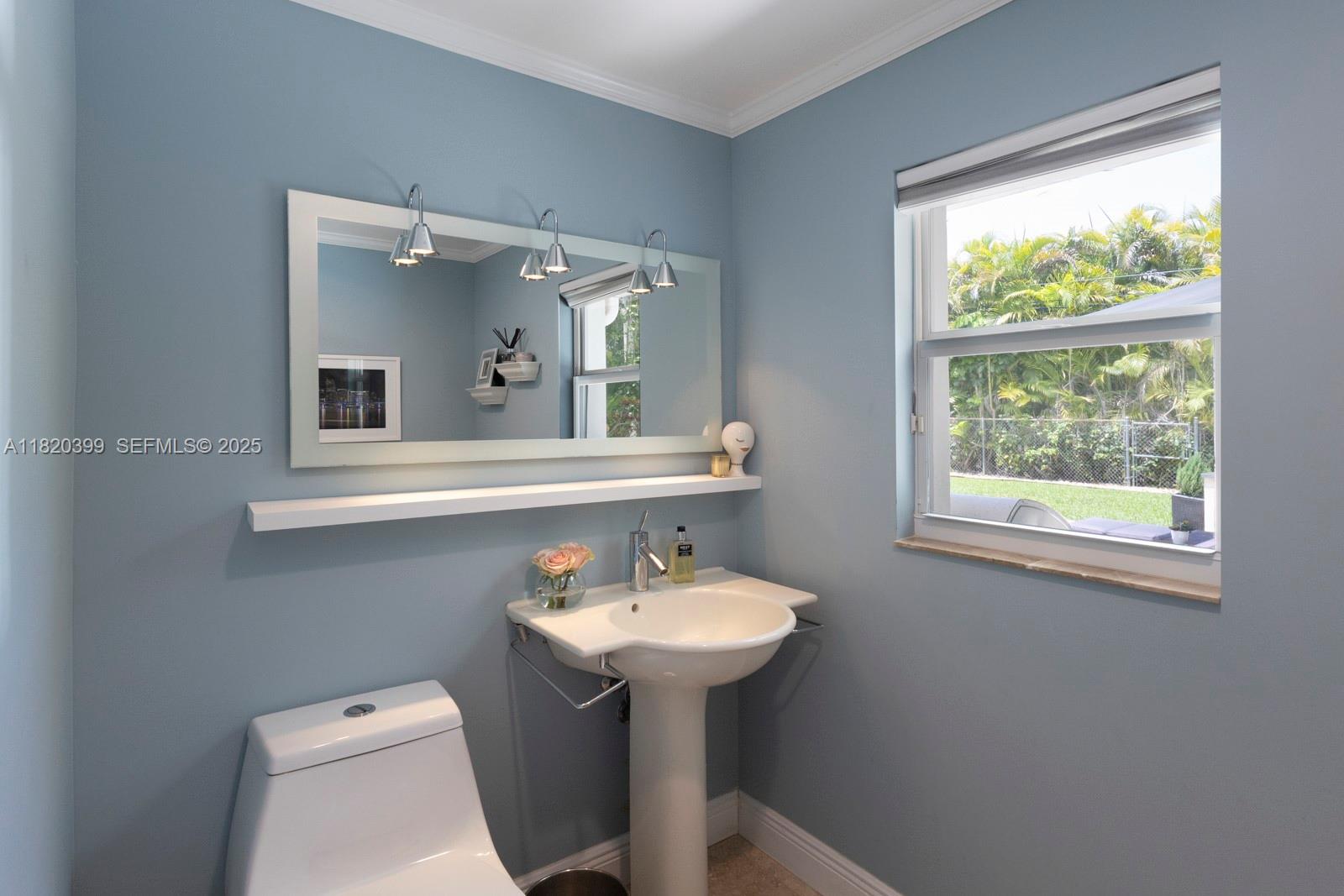 11900 Southwest 72nd Place Pinecrest, FL 33156 - Photo 13 of 37 a bathroom with a toilet sink and mirror