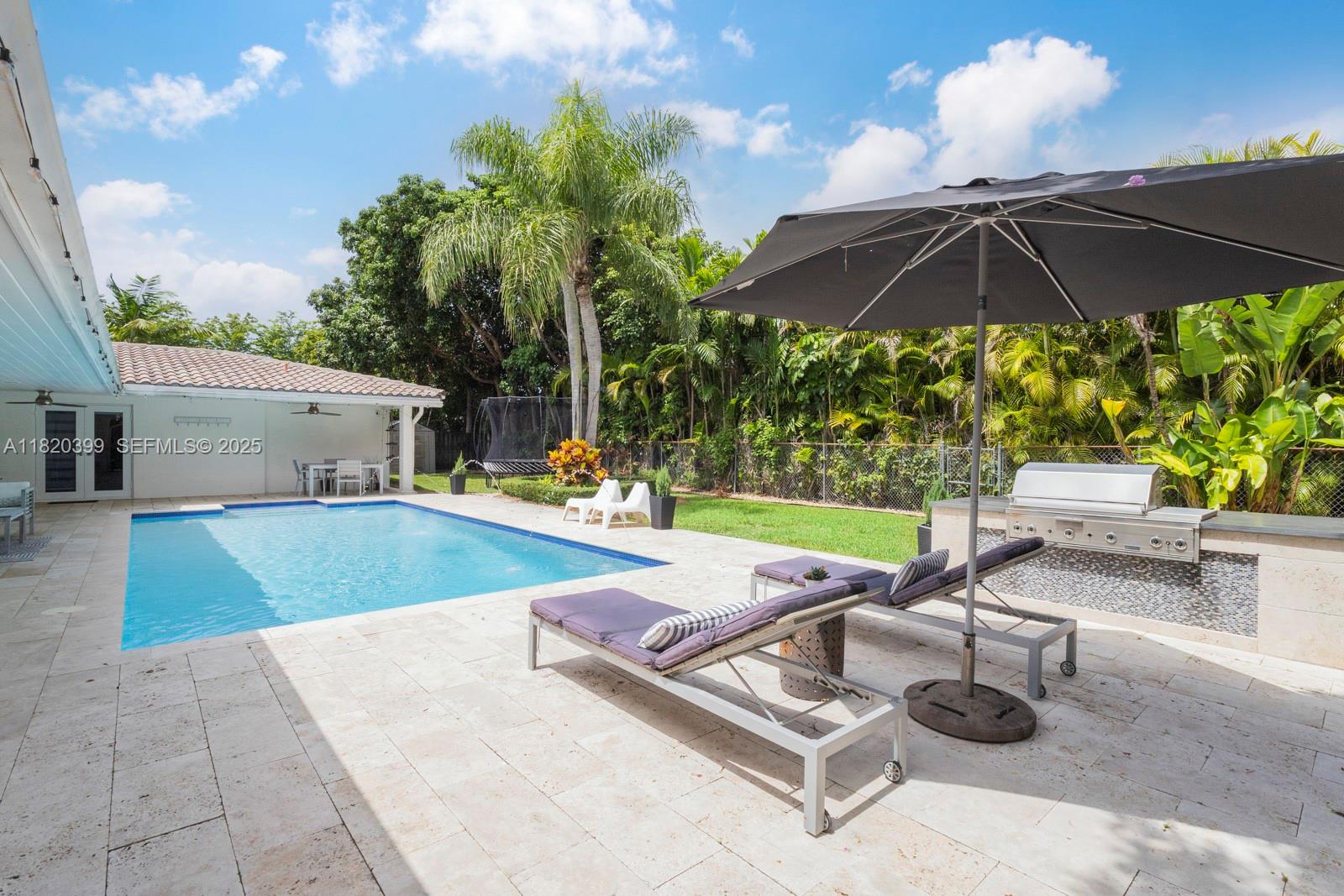 11900 Southwest 72nd Place Pinecrest, FL 33156 - Photo 14 of 37 a view of a backyard with sitting area and furniture