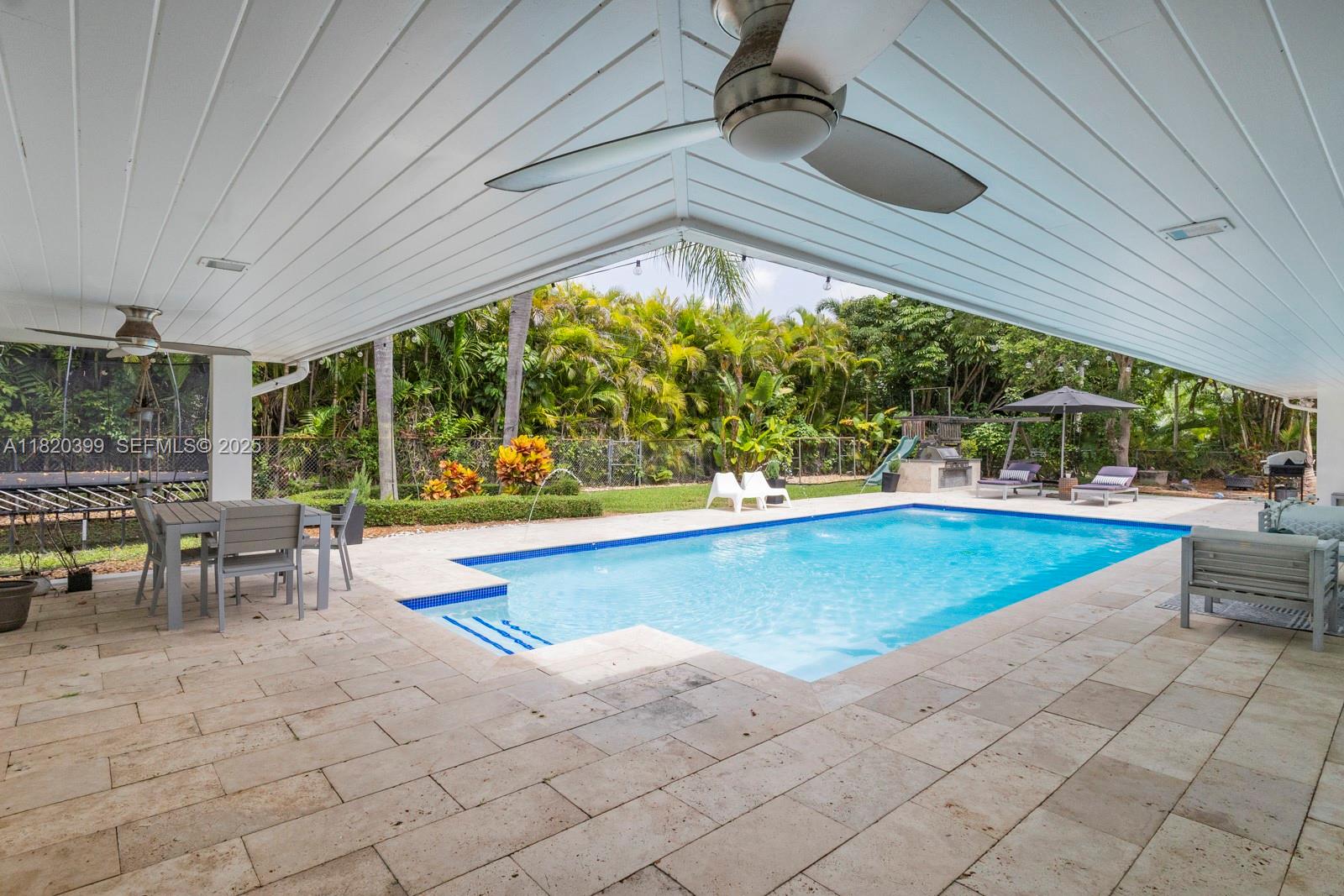 11900 Southwest 72nd Place Pinecrest, FL 33156 - Photo 15 of 37 a view of swimming pool with seating space