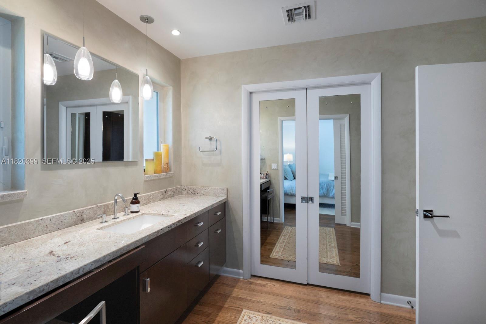 11900 Southwest 72nd Place Pinecrest, FL 33156 - Photo 18 of 37 a spacious bathroom with a granite countertop sink a mirror and a shower