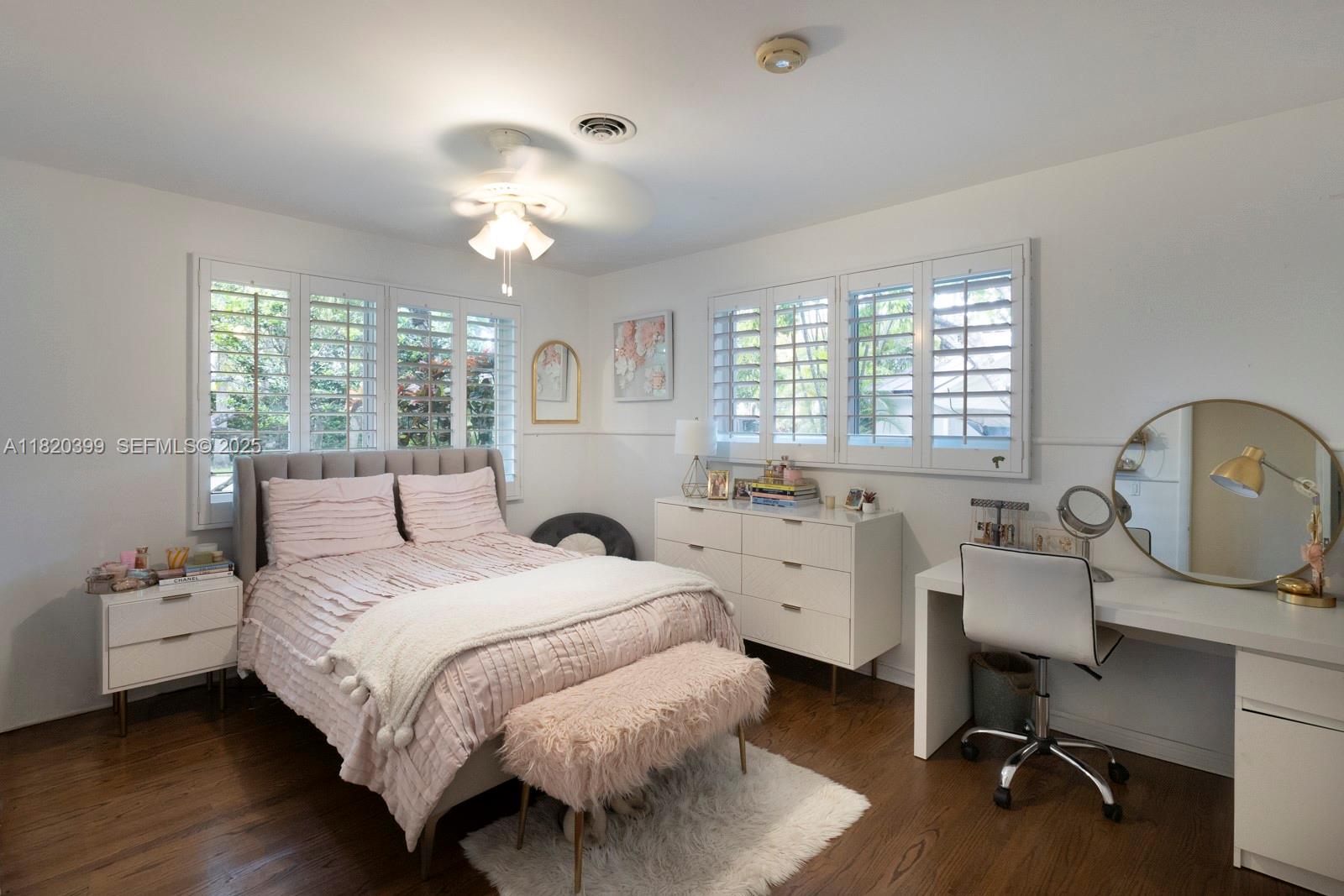 11900 Southwest 72nd Place Pinecrest, FL 33156 - Photo 19 of 37 a bedroom with a bed and a chandelier