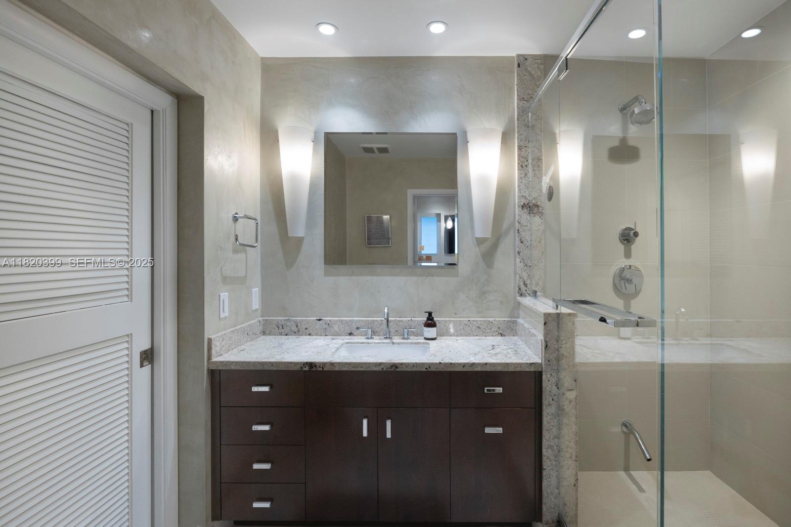 11900 Southwest 72nd Place Pinecrest, FL 33156 - Photo 20 of 37 a bathroom with a double vanity sink mirror and shower