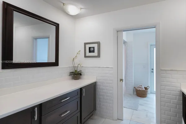 a bathroom with a sink a mirror and vanity