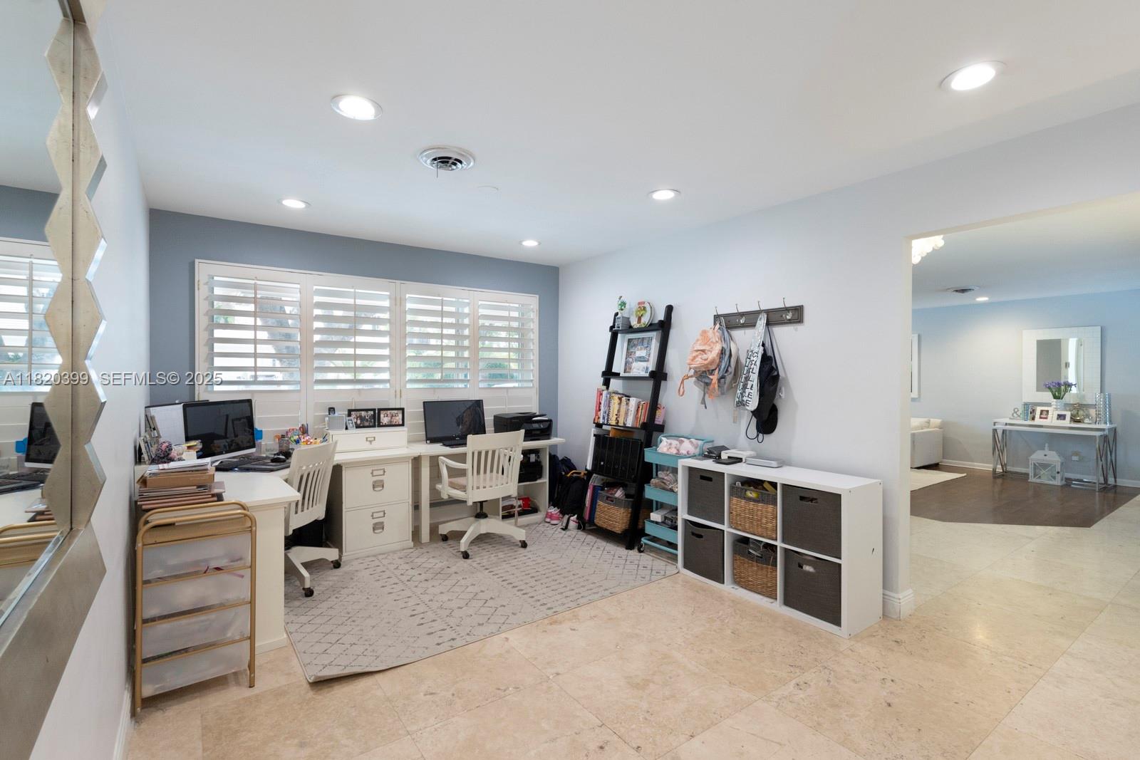11900 Southwest 72nd Place Pinecrest, FL 33156 - Photo 26 of 37 a living room with furniture a large window and gym equipment