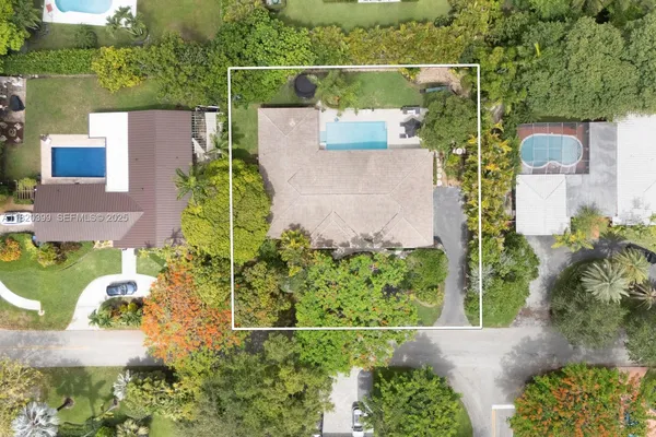 an aerial view of a house with a yard and lake view