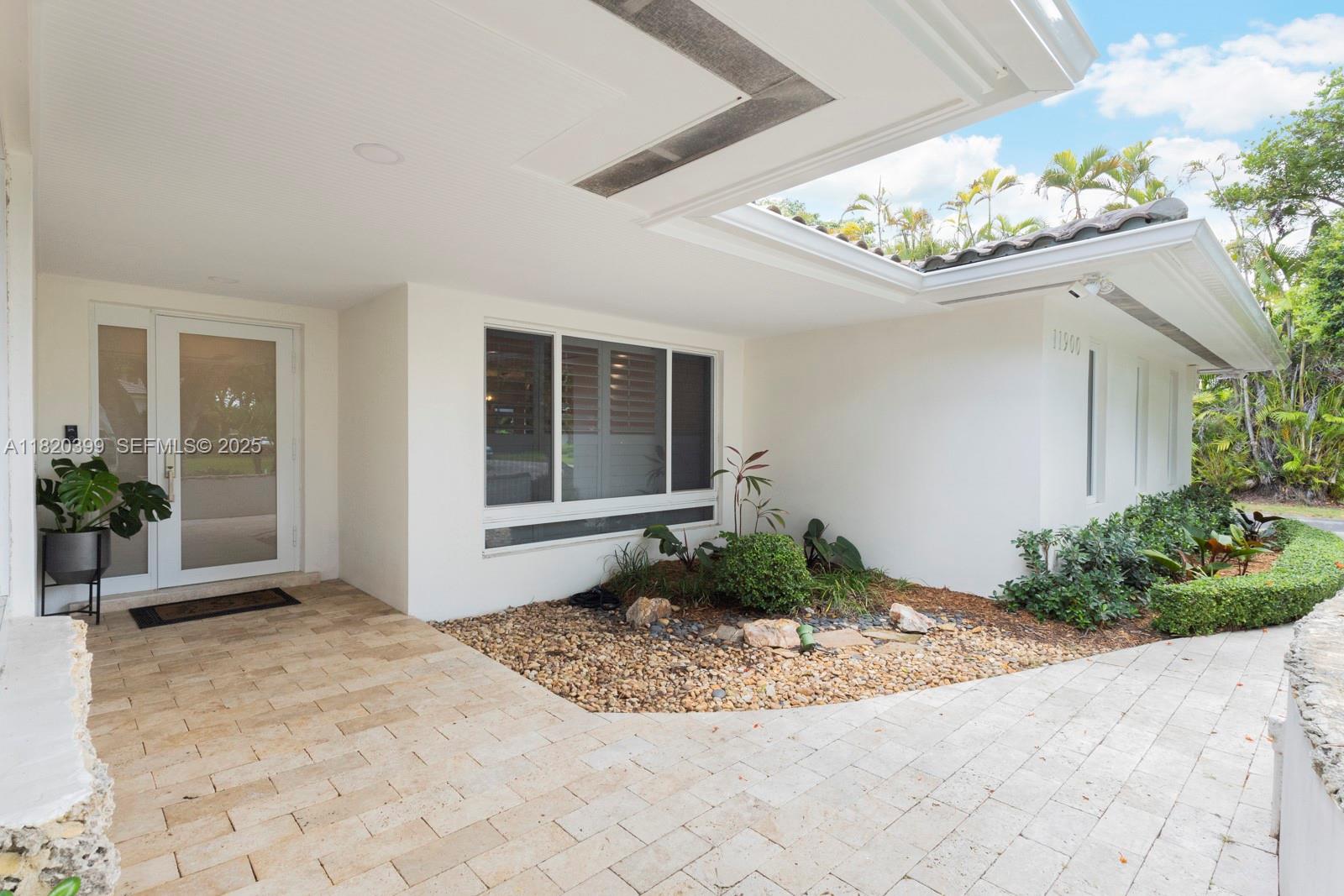 11900 Southwest 72nd Place Pinecrest, FL 33156 - Photo 4 of 37 a view of a entryway in front of house