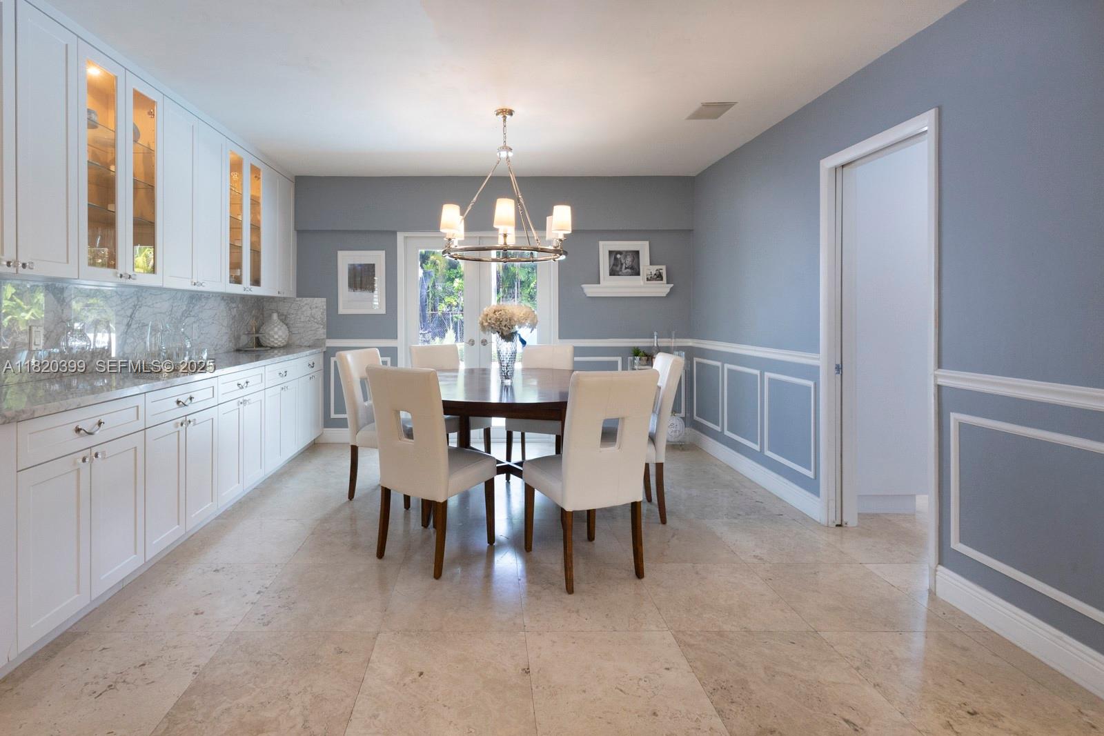 11900 Southwest 72nd Place Pinecrest, FL 33156 - Photo 7 of 37 a view of a dining room with furniture and chandelier