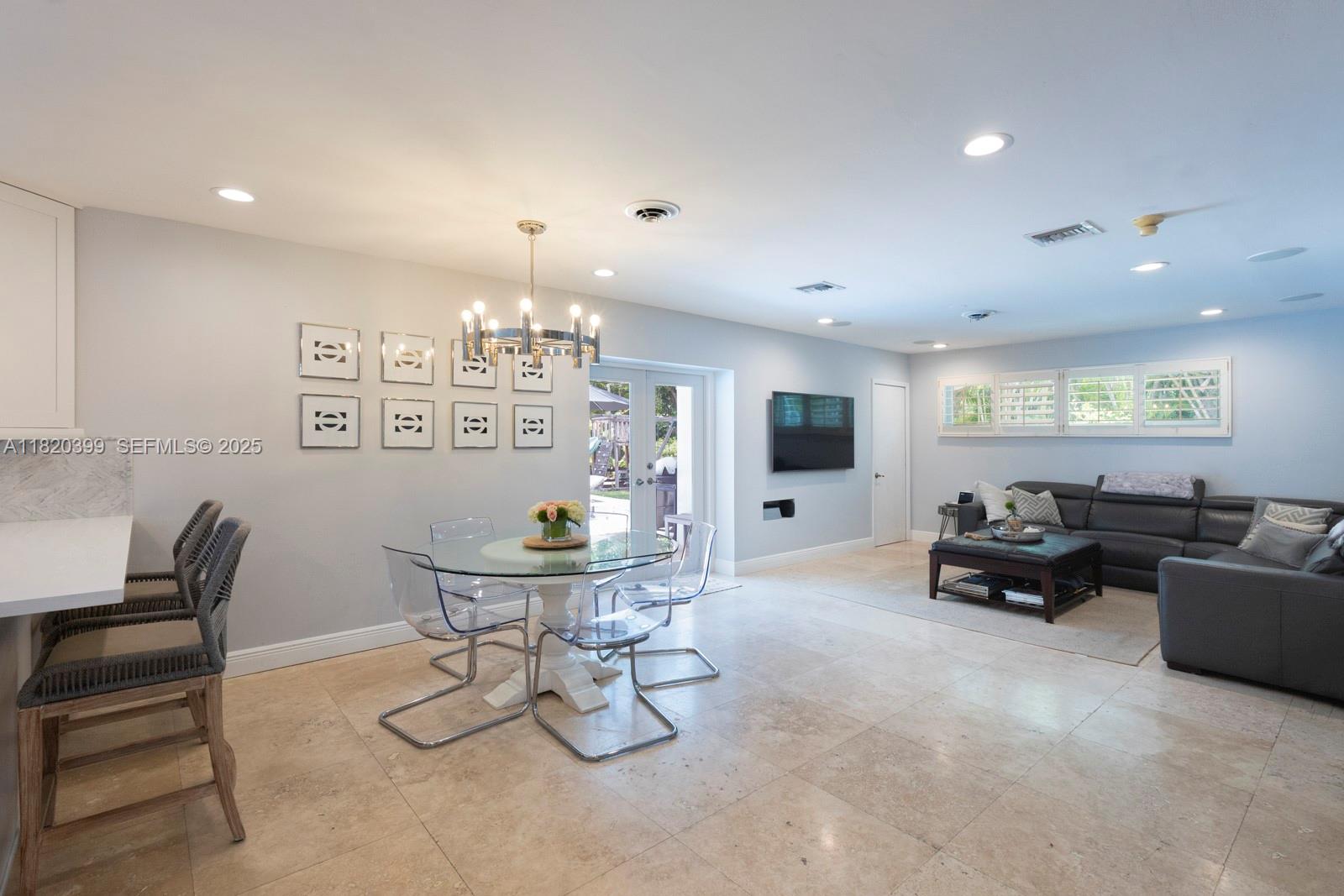 11900 Southwest 72nd Place Pinecrest, FL 33156 - Photo 8 of 37 a living room with furniture and a flat screen tv