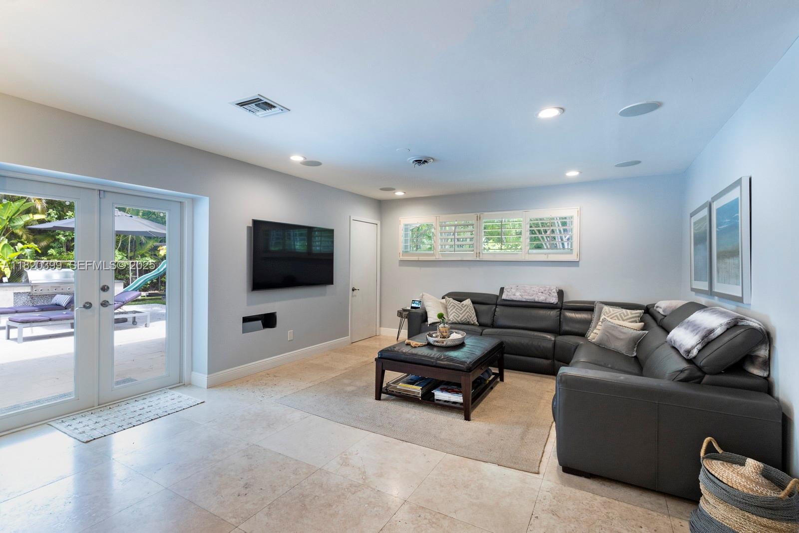 11900 Southwest 72nd Place Pinecrest, FL 33156 - Photo 9 of 37 a living room with furniture and a flat screen tv