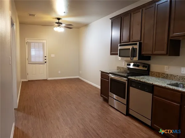 a kitchen with a sink appliances and cabinets