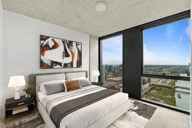 a bedroom with a balcony a bed and a painting on the wall