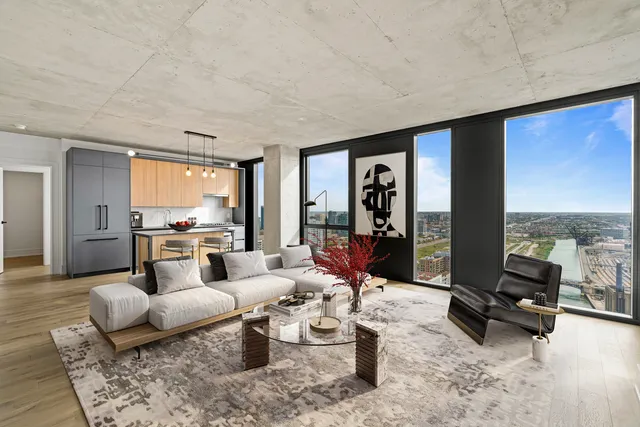 a living room with furniture and large windows