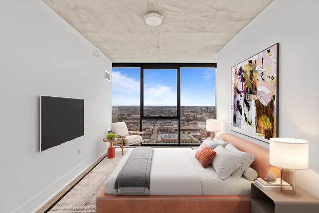 a bedroom with a large bed and a flat screen tv