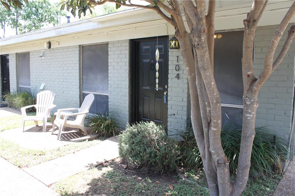 Entrance to property featuring brick siding