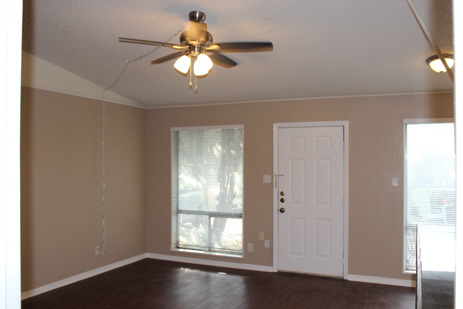 606 West 51st Street, Unit 104 Austin, TX 78751 - Photo 15 of 21 Foyer with ceiling fan, dark wood-style flooring, crown molding, and a textured ceiling