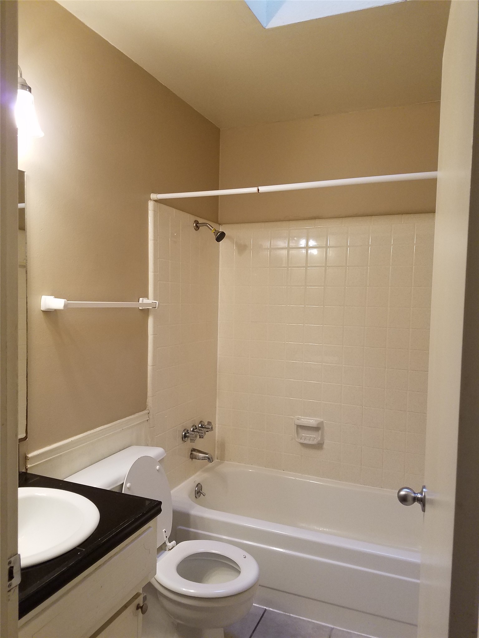 606 West 51st Street, Unit 104 Austin, TX 78751 - Photo 16 of 21 Full bathroom with vanity, shower combination, and tile patterned floors
