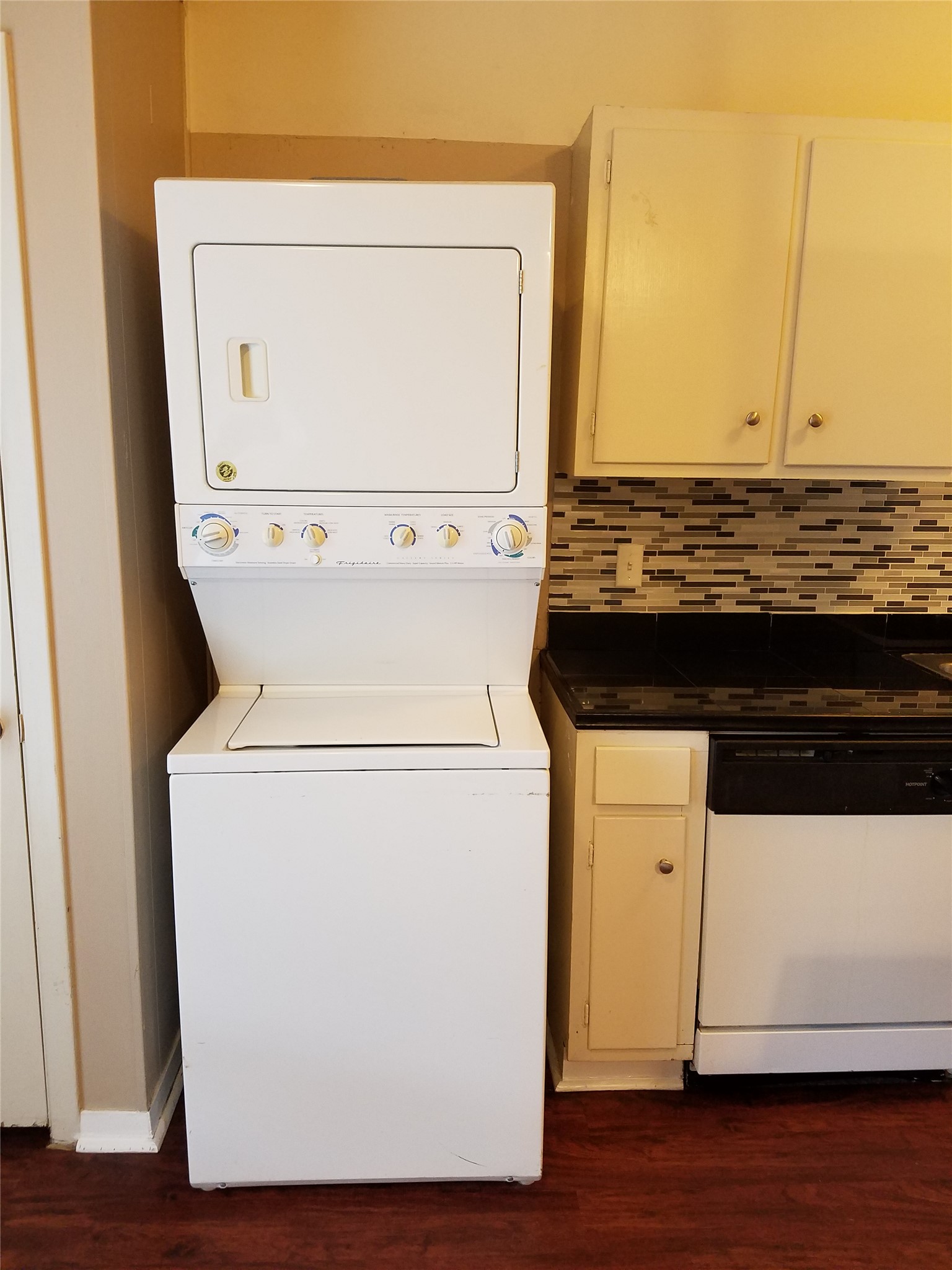 606 West 51st Street, Unit 104 Austin, TX 78751 - Photo 20 of 21 Laundry area featuring dark wood-style floors and stacked washer and clothes dryer