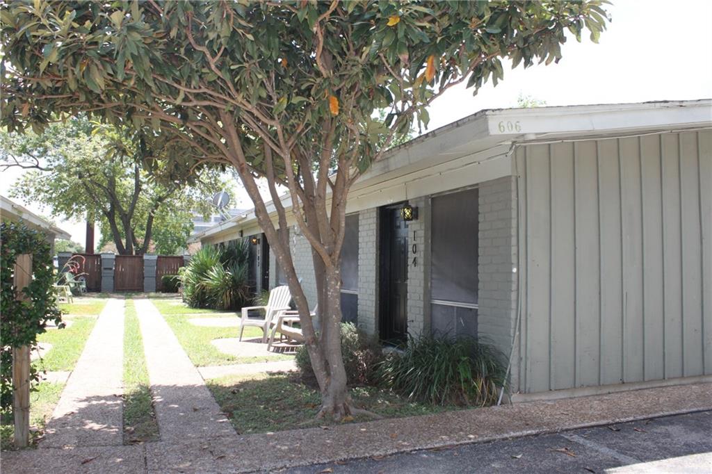 606 West 51st Street, Unit 104 Austin, TX 78751 - Photo 5 of 21 View of home's exterior featuring brick siding, board and batten siding, and a gate