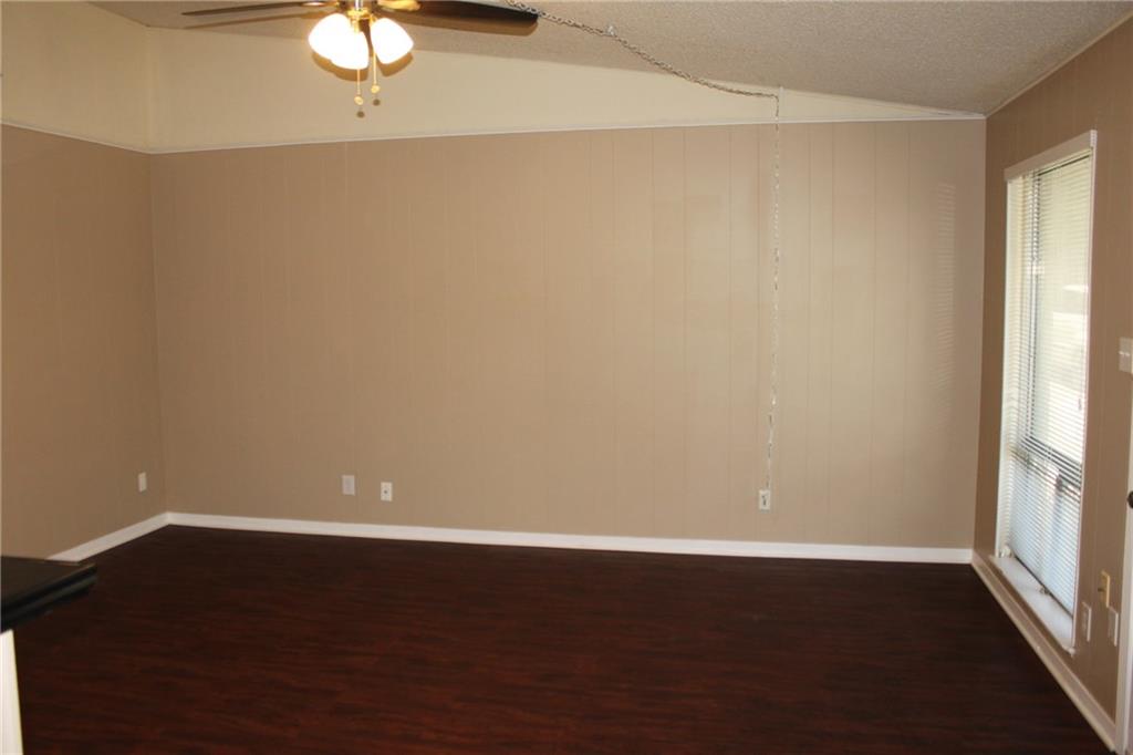 606 West 51st Street, Unit 104 Austin, TX 78751 - Photo 6 of 21 Spare room with a ceiling fan, dark wood-style floors, and a textured ceiling
