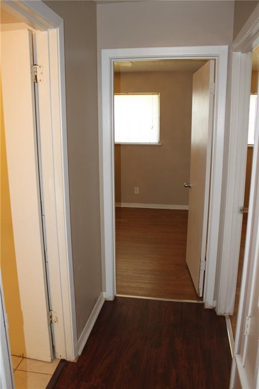 606 West 51st Street, Unit 104 Austin, TX 78751 - Photo 7 of 21 Hallway featuring dark wood-type flooring and baseboards