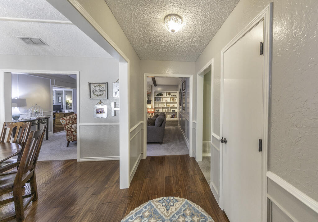 3620 93rd Street Lubbock, TX 79423 - Photo 10 of 33 a view of a hallway view with wooden floor and furniture