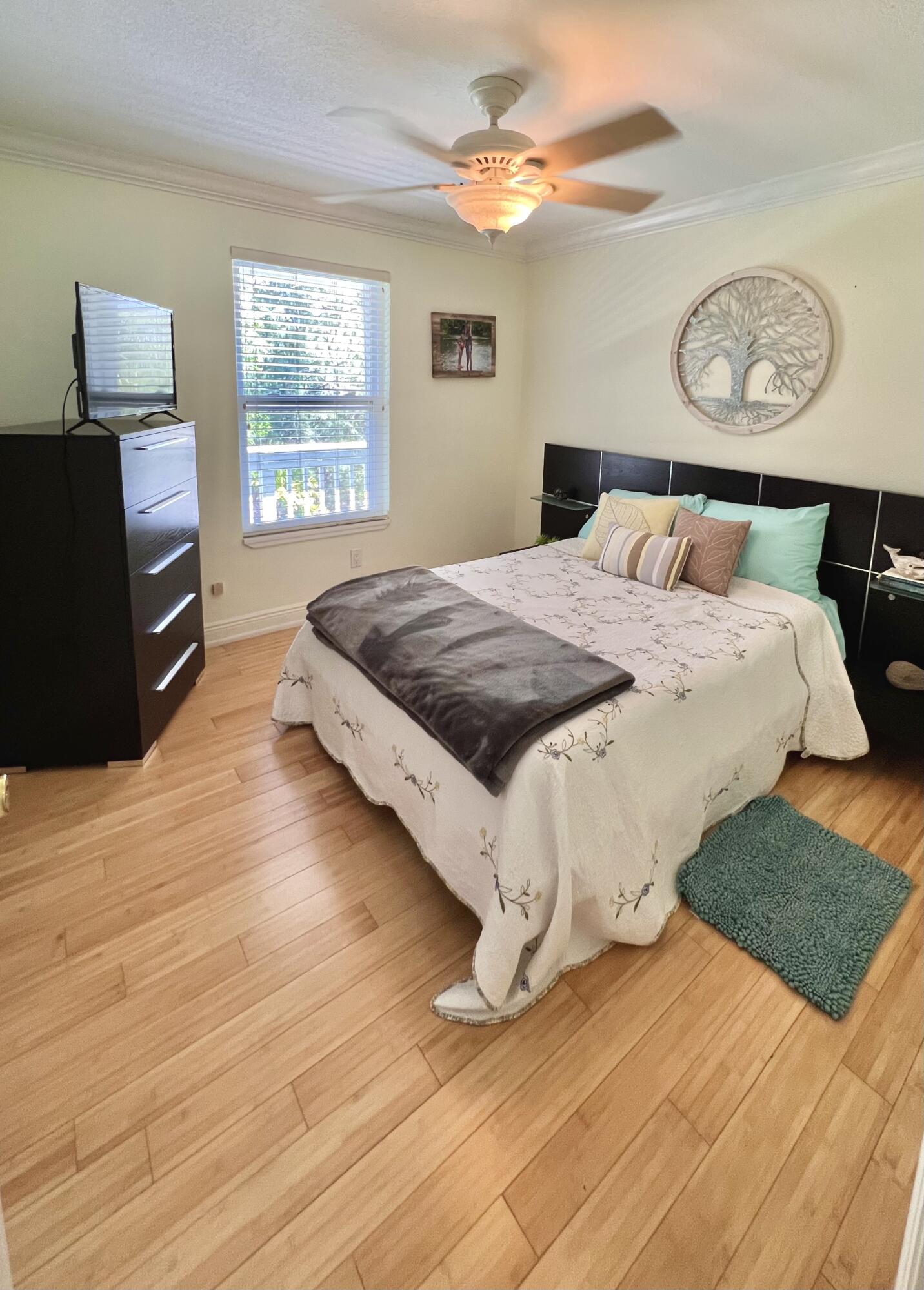 24 Bounty Lane Key Largo, FL 33037 - Photo 10 of 36 a bedroom with a bed and dresser with wooden floor