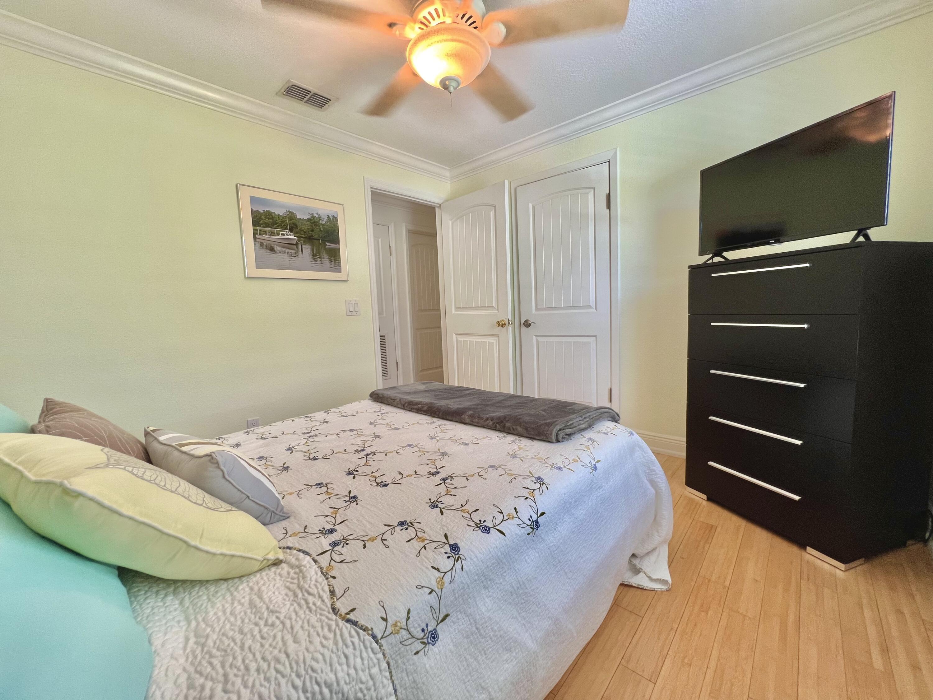 24 Bounty Lane Key Largo, FL 33037 - Photo 11 of 36 a bedroom with a bed and a flat screen tv