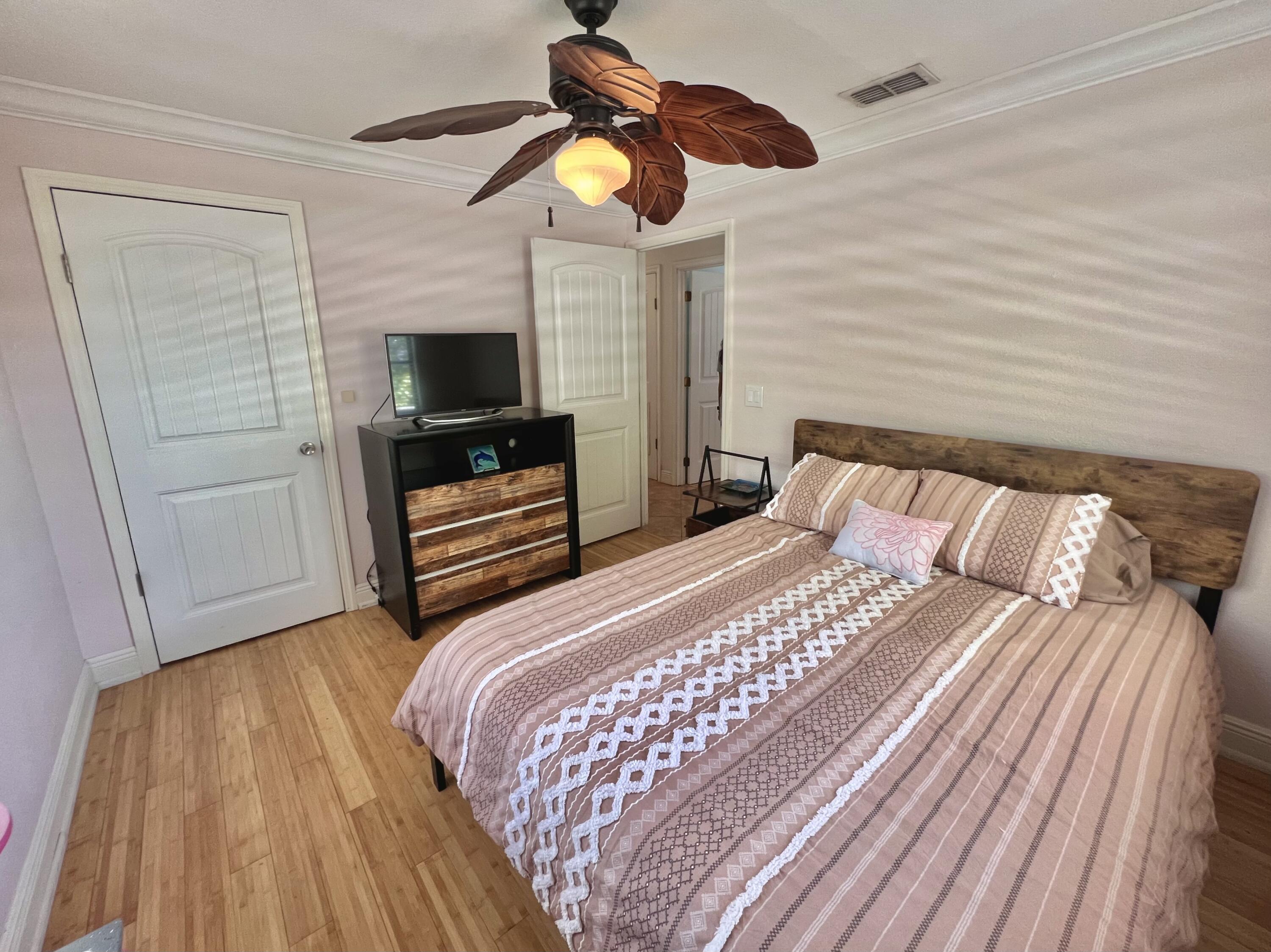 24 Bounty Lane Key Largo, FL 33037 - Photo 12 of 36 a bedroom with a bed and a television